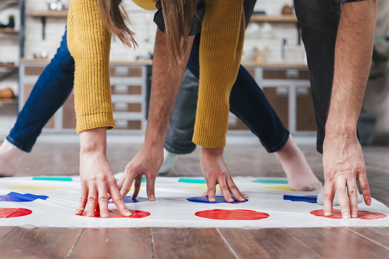 Close up of the arms and legs of people playing Twister