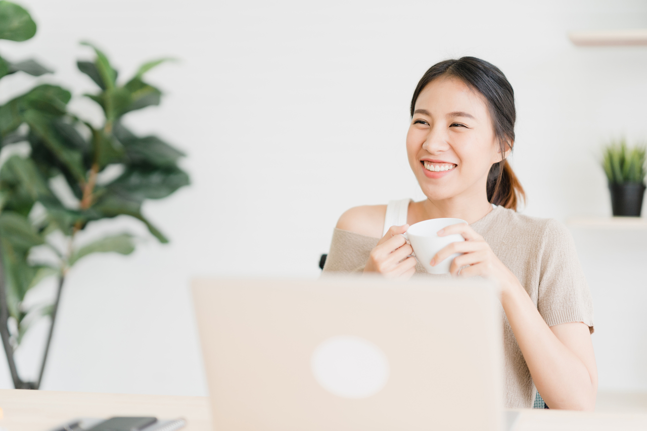 Girl smiling in front of her laptop