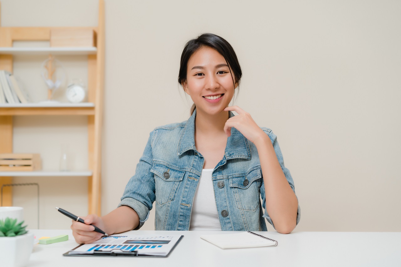 An asian girl smiling while planning a party