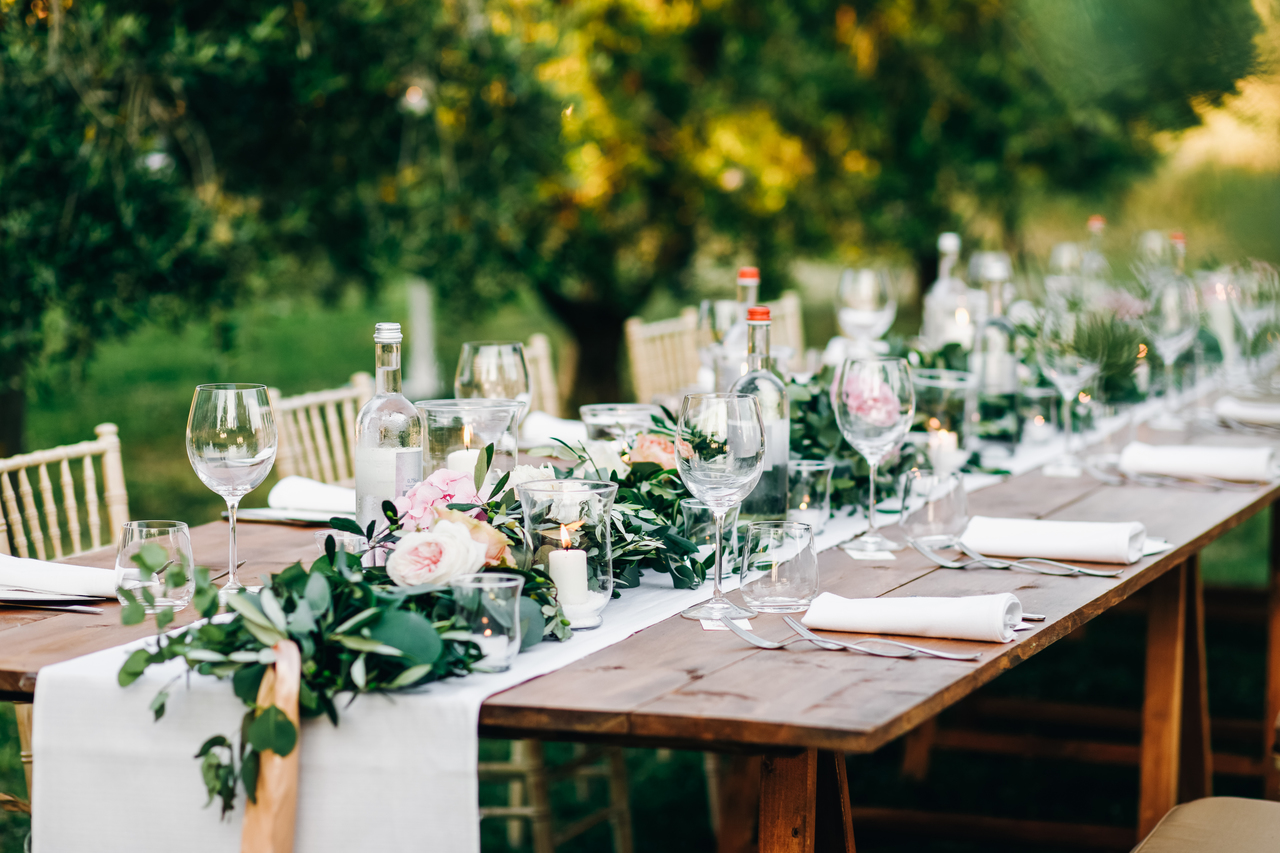 Wooden chairs and tables for an outdoor wedding reception