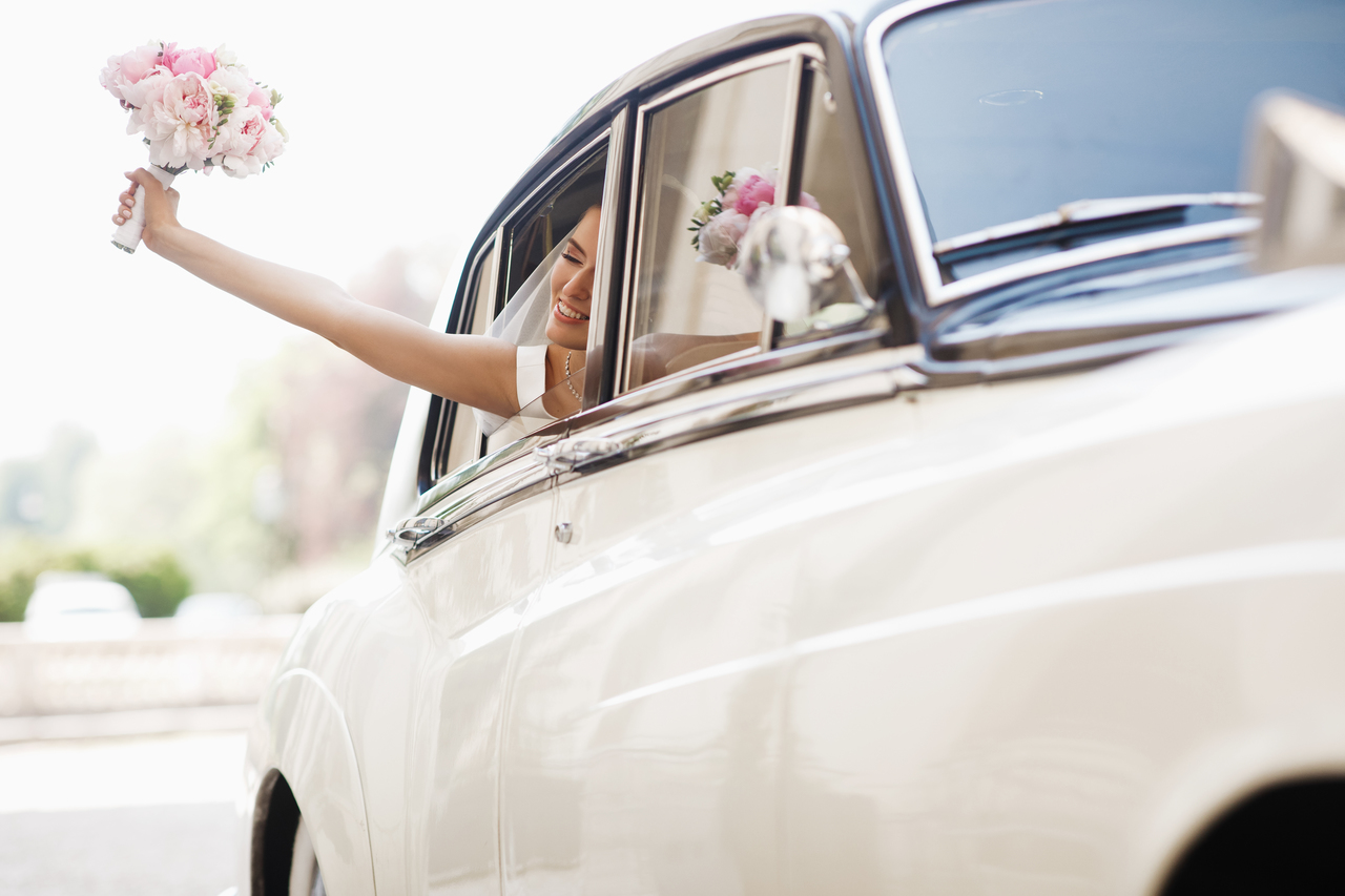 A bride riding a rented car