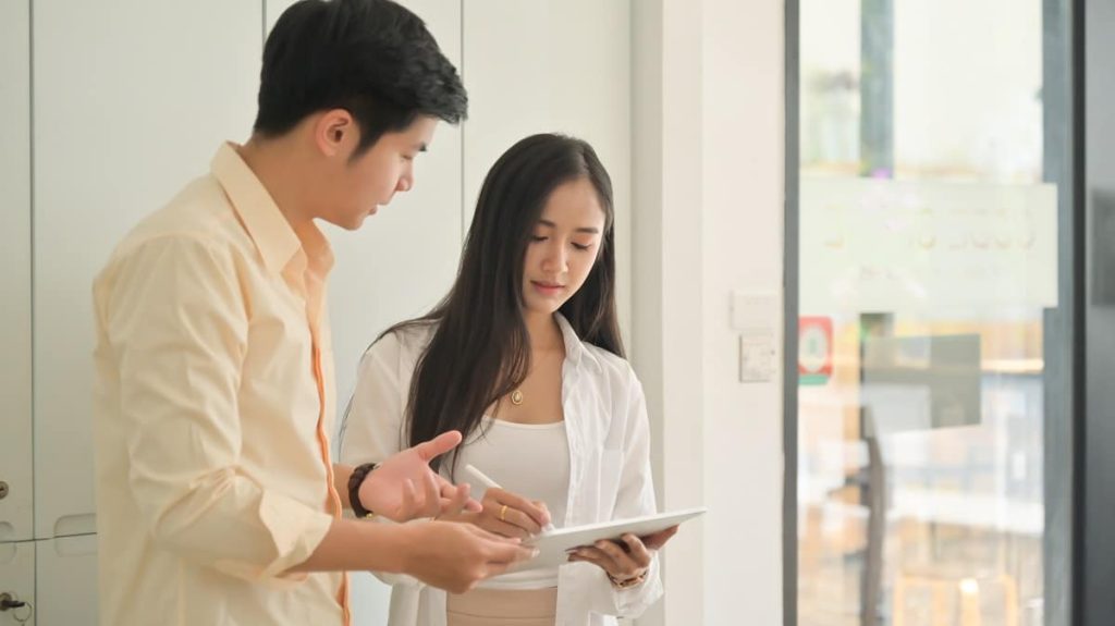 Shot of Young men and women use tablets to find and plan their w