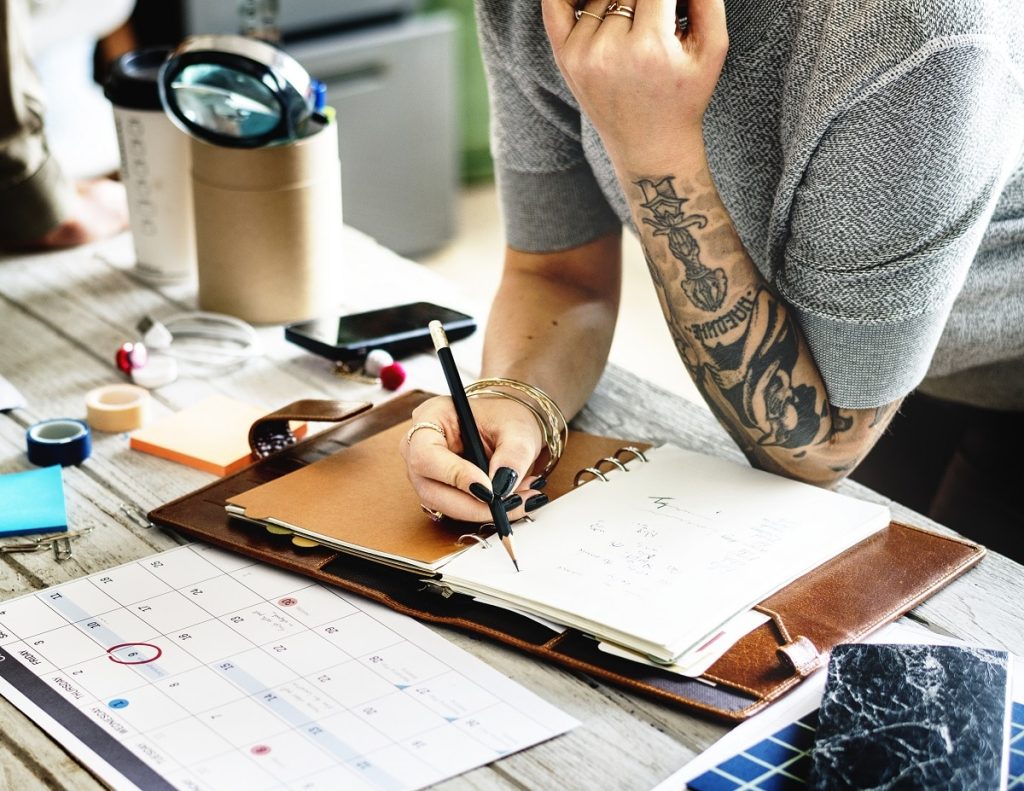 Tattooed woman planning