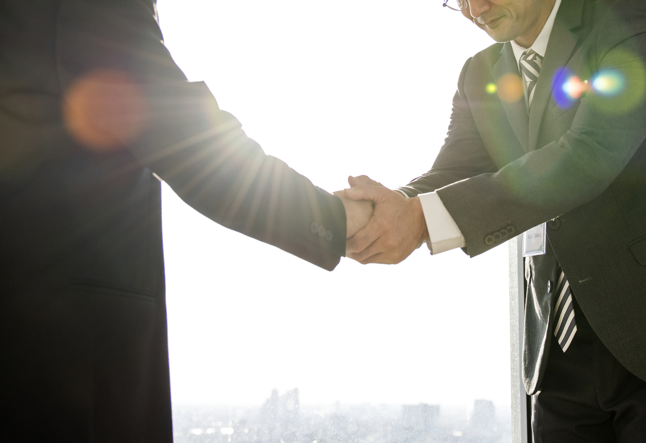 A business owner and an investor shaking hands